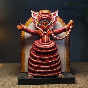 Handcrafted Wooden Sculpture of a Traditional Indian Goddess  Theyyam. Vibrant and Detailed Decor Piece.