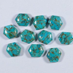 May include: Ten turquoise cabochons with gold flecks, cut in a hexagonal shape. The stones are a vibrant blue-green colour and have a smooth, polished finish.