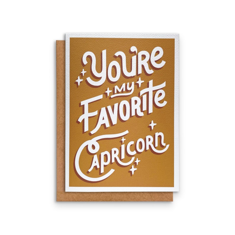 May include: A gold card with white text that reads "You're my favourite Capricorn".