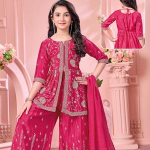 May include: A bright pink three-piece outfit featuring a knee-length tunic with a front slit, wide-leg trousers, and a matching dupatta. The set is decorated with intricate gold floral embroidery and metallic thread work on the hem and bodice.