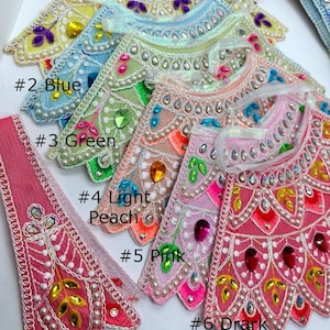 May include: Six different colors of fabric trim with pearl and rhinestone embellishments. The colors are yellow, blue, green, light peach, pink, and dark peach/pink. The trim is labeled with numbers 1 through 6.