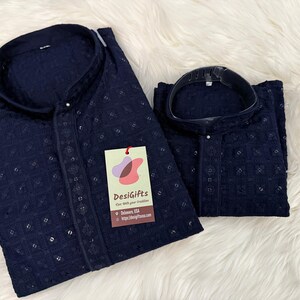 May include: Two navy blue shirts with a delicate embroidered pattern. The shirts have a mandarin collar and a button closure. The shirts are made of a soft, breathable fabric. The shirts are perfect for a casual or formal occasion.