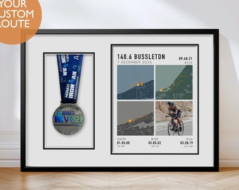 May include: Framed black print with a medal and race details. The medal is silver with a blue ribbon. The print includes the text "140.6 Busselton 7 December 2025" and race times for swim, bike, and run. The top left corner has the text "YOUR CUSTOM ROUTE".