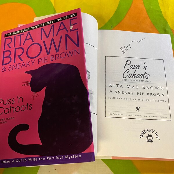 RITA MAE BROWN Autographed Copy “Puss ‘n Cahoots” Book! New York Times Best Selling Author of Sneaky Pie Brown Novels! 100% Authentic!