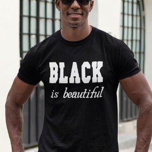 May include: A black t-shirt with white text that reads "BLACK is beautiful".