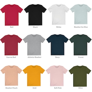 May include: A selection of t-shirts in various colors, including red, black, white, heather ice blue, canvas red, athletic heather, navy, forest, heather peach, gold, soft pink, and olive.