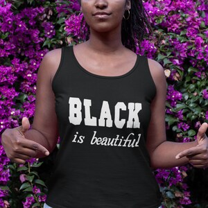 May include: Black tank top with the text "BLACK is beautiful" in white lettering.