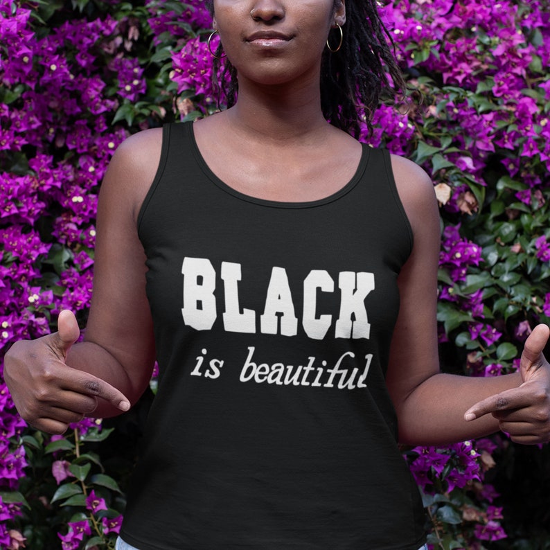 May include: Black tank top with the text "BLACK is beautiful" in white lettering.