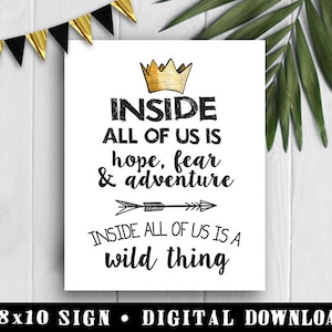 May include: A white 8x10 inch sign with black text that reads "INSIDE ALL OF US IS hope, fear & adventure INSIDE ALL OF US IS A wild thing". The sign also features a gold crown and a black and white arrow.