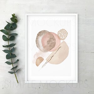 May include: A white frame with a white mat surrounding a print of abstract shapes in shades of pink, brown, and gold. The print is on a white background.