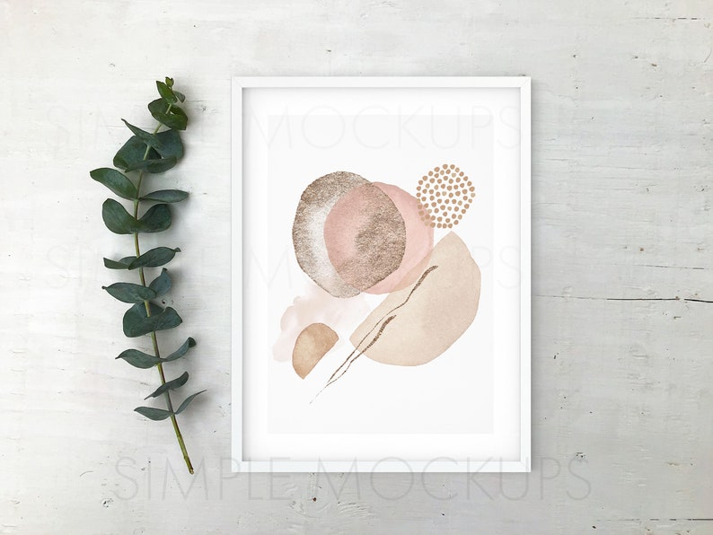 May include: A white frame with a white mat surrounding a print of abstract shapes in shades of pink, brown, and gold. The print is on a white background.