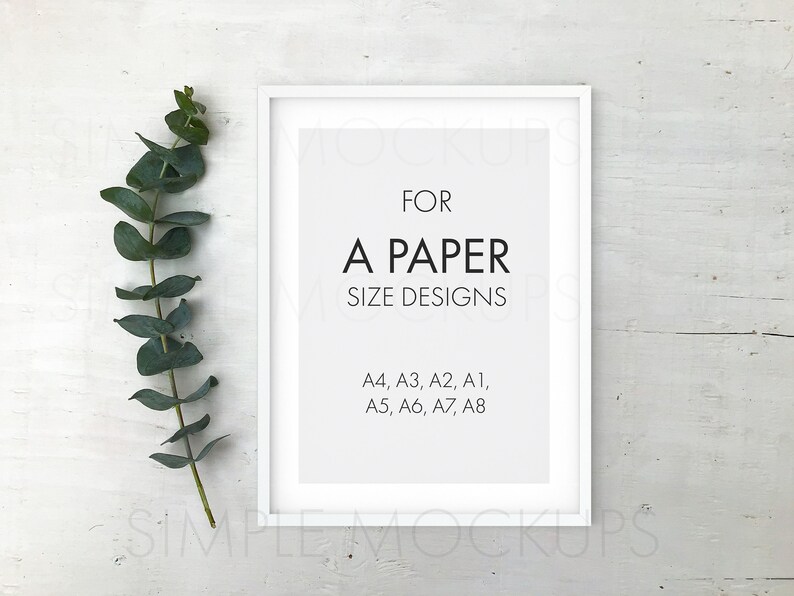 May include: White picture frame mockup with a white mat and a text overlay that reads "FOR A PAPER SIZE DESIGNS A4, A3, A2, A1, A5, A6, A7, A8". A sprig of eucalyptus is to the left of the frame.