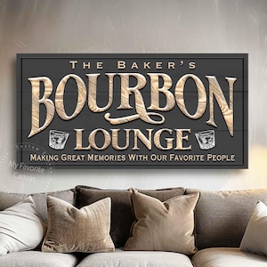 May include: A grey wooden sign with the text "The Baker's Bourbon Lounge" in brown lettering. The sign also includes two small images of glasses of bourbon. The text "Making Great Memories With Our Favorite People" is below the main text.