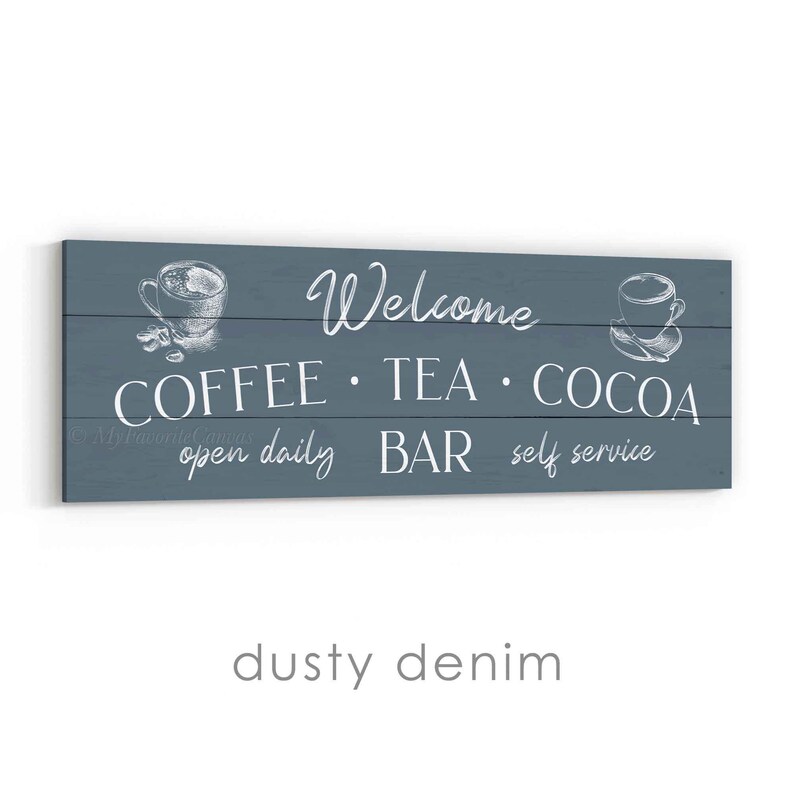May include: A rectangular sign with a dusty denim background features the words "Welcome" and "COFFEE &bull; TEA &bull; COCOA" in white script. The sign also includes the phrases "open daily," "BAR," and "self service." White line drawings of coffee cups are on each side.