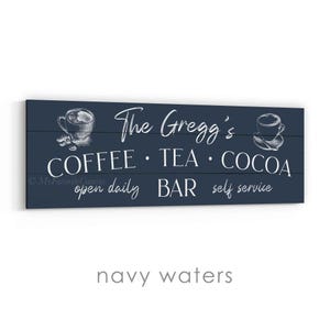 May include: Navy blue wooden sign with white text that reads "The Gregg's COFFEE &bull; TEA &bull; COCOA" with coffee and tea cup illustrations. The sign also says "open daily BAR self service".