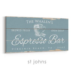 Pode incluir: Uma placa retangular de madeira azul desgastada com texto branco que diz "THE WHALEN'S Espresso Bar" e "BREWED FRESH, OPEN DAILY". Um gr&aacute;fico de x&iacute;cara de caf&eacute; est&aacute; no centro. A placa tamb&eacute;m diz "VIRGINIA BEACH, VA 2002".