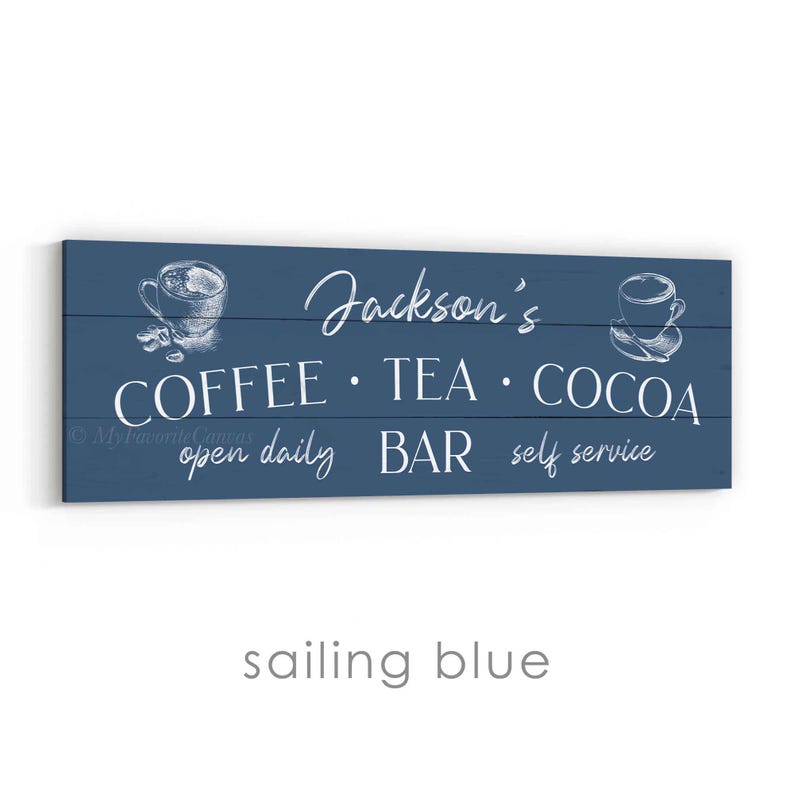 May include: A rectangular, sailing blue wooden sign with white text. The sign reads "Jackson's COFFEE &bull; TEA &bull; COCOA BAR open daily self service" with sketched coffee cup illustrations. The sign is designed for a coffee, tea, and cocoa bar.