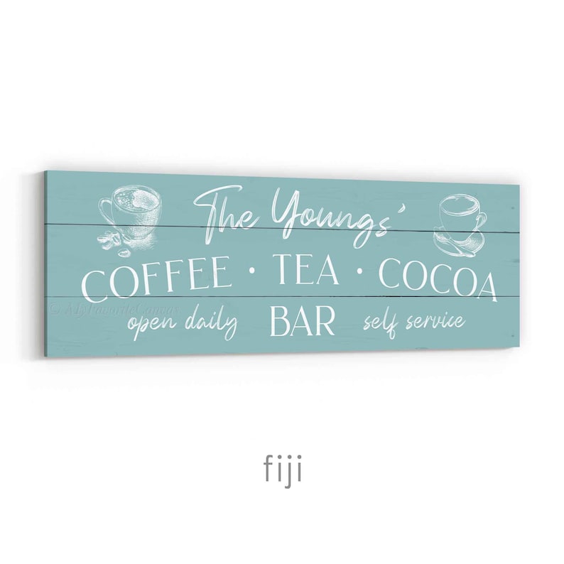 May include: A rectangular, pale blue wooden sign with white text and illustrations. The sign reads "The Youngs' COFFEE &bull; TEA &bull; COCOA BAR open daily self service". The sign has illustrations of coffee cups.