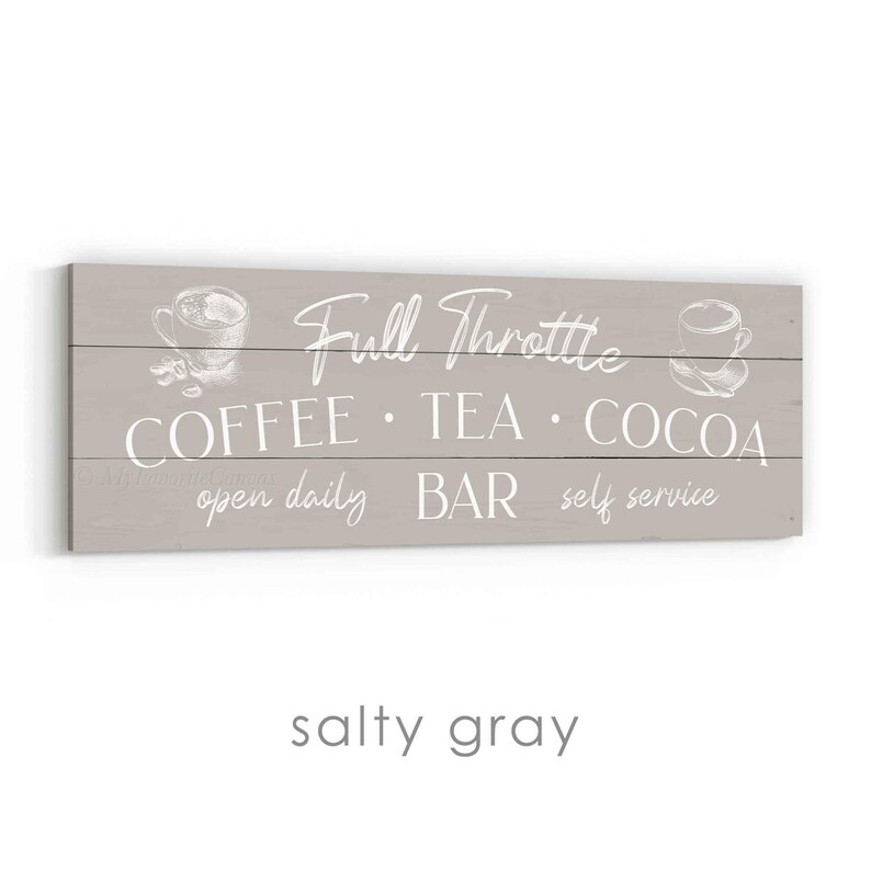 May include: A rectangular, light grey wooden sign with white text. The sign reads "Full Throttle COFFEE &bull; TEA &bull; COCOA open daily BAR self service" with sketched coffee cup illustrations. The bottom of the sign reads "salty grey".