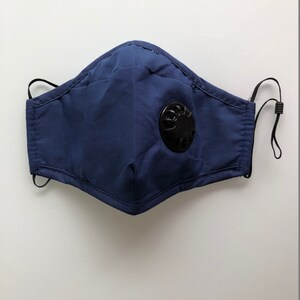 May include: A dark blue face mask with a black valve. The mask has elastic ear loops.