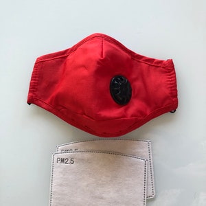 May include: Red face mask with a black valve and two white PM2.5 filter inserts.