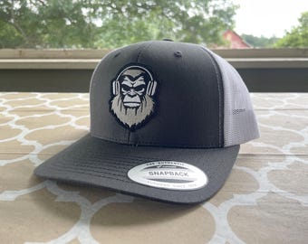 Giant Step Design Co  Embroidered Bigfoot Sasquatch Headphones Patch Retro Mesh Trucker Hat - Charcoal / White Yupoong  YP CLASSIC