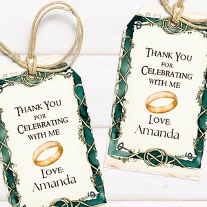 May include: Two wedding favor tags with a cream background and a green and gold border. The tags have the text "Thank You for Celebrating with Me" and "Love: Amanda" with a gold ring graphic. Each tag is tied with twine.