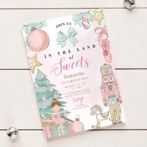 May include: A party invitation with a watercolor design. The invitation reads "In the Land of Sweets" and includes illustrations of a ballerina, nutcracker, and Christmas tree. The invitation is for Samantha's first birthday.