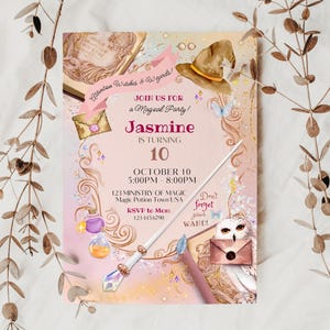 May include: A pink and gold invitation for a magical party. The invitation features a witch's hat, a wand, a potion bottle, and an owl. The text on the invitation reads "Attention Witches & Wizards! Join us for a Magical Party! Jasmine is turning 10. October 10, 5:00PM - 8:00PM, 123 Ministry of Magic, Magic Potion Town USA. RSVP to Mom, 123 445 6790. Don't forget your WAND!"