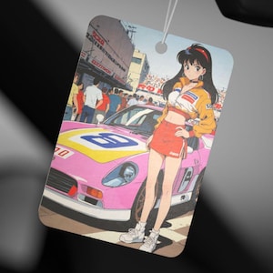 May include: A pink and yellow racing car with a woman in a red and white racing outfit standing next to it. The car has a large number "8" on the side. The woman has long black hair and is wearing a white shirt with a red and white racing stripe. The background is a city street with buildings and people.