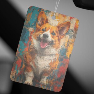 Puede incluir: Una pintura abstracta colorida de un perro corgi con una expresión feliz. El perro es marrón y blanco con la lengua rosa que sobresale. El fondo es una mezcla de azul, naranja, amarillo y rojo.