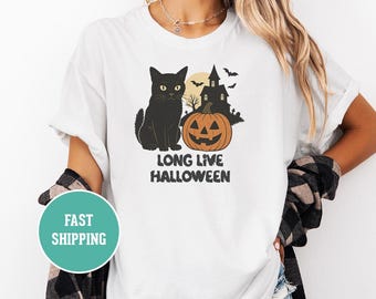 May include: White t-shirt featuring a black cat, jack-o'-lantern, haunted house, and bats. The text "LONG LIVE HALLOWEEN" is printed below the graphic. The shirt is a casual, comfortable style.