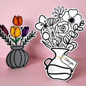 May include: Two paper flower arrangements in vases. One vase holds colorful tulips in orange, yellow, and purple. The other vase holds black and white line art flowers with a tag that says "i love you". The background is pink.