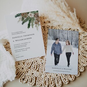 Puede incluir: Invitaci&oacute;n de boda con tem&aacute;tica invernal. La invitaci&oacute;n presenta texto y un borde decorativo de pi&ntilde;as y vegetaci&oacute;n. Una segunda tarjeta muestra a una pareja caminando en la nieve. El texto dice "DANIELLE THOMPSON & WILLIAM JACKSON".