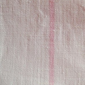 May include: White fabric with a single pink stripe running vertically down the centre.