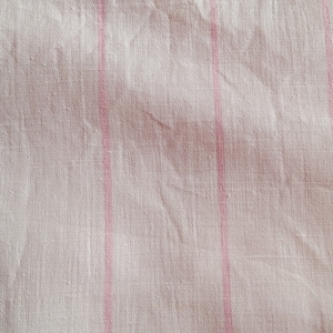 May include: White fabric with thin pink stripes. The fabric has a subtle texture and is slightly wrinkled.