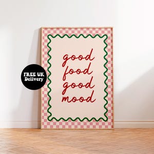 May include: A pink and green chequered framed print with the text "good food good mood" in red cursive writing.