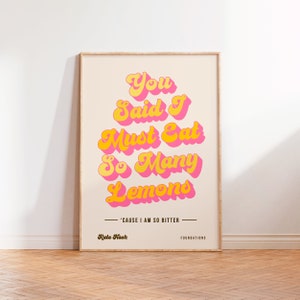 May include: A poster with a retro font design that reads "You Said I Must Eat So Many Lemons 'Cause I Am So Bitter." The poster is in pink and yellow with the text "Kate Nash" and "FOUNDATIONS" at the bottom.