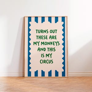 May include: A pink and blue striped poster with the text "Turns out these are my monkeys and this is my circus" in green lettering.