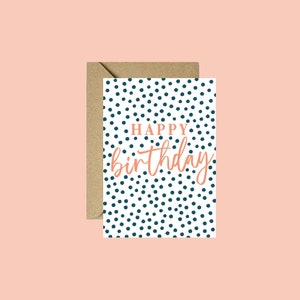 May include: A white card with a blue polka dot pattern and the text "HAPPY birthday" in orange.