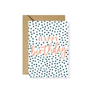 May include: A white card with a blue polka dot pattern and the text "Happy birthday" in orange.