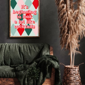 May include: A framed print with a green, red, and pink diamond pattern. The text on the print reads "It's beginning to look a lot like cocktails."