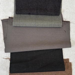 May include: A collection of fabric swatches in various colors and textures. The swatches include black, gray, and brown fabrics, with some featuring a woven or checkered pattern. The text "Set #2" is visible at the top.
