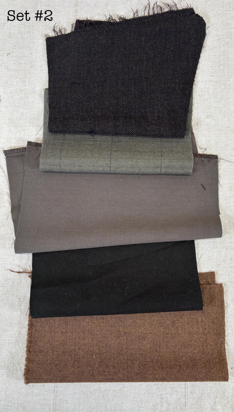 May include: A collection of fabric swatches in various colors and textures. The swatches include black, gray, and brown fabrics, with some featuring a woven or checkered pattern. The text "Set #2" is visible at the top.