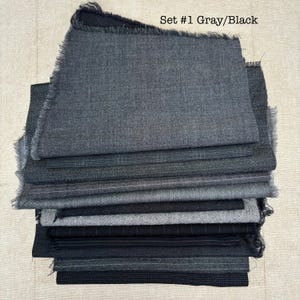 May include: A stack of gray and black fabric swatches with frayed edges. The fabrics vary in texture and pattern, including solid, plaid, and pinstripe designs. The text "Set #1 Gray/Black" is visible at the top.