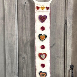 May include: A set of three ceramic mugs with a speckled, matte finish. The mugs are in shades of cream, light gray, and dark gray. Each mug has a simple, minimalist design, perfect for coffee or tea.