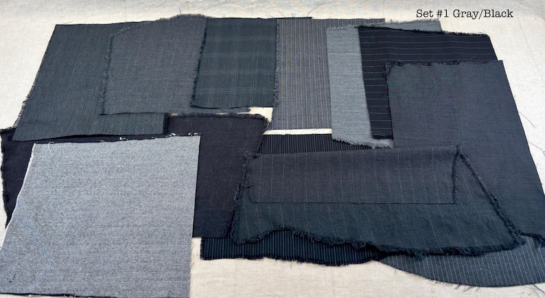 May include: A collection of gray and black fabric swatches with frayed edges. The swatches vary in texture and pattern, including solid, striped, and plaid designs. The text "Set #1 Gray/Black" is visible in the upper right corner.