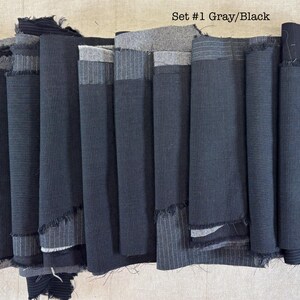 May include: A collection of gray and black fabric scraps, arranged in a vertical stack. The fabrics vary in texture and pattern, including stripes and solid colors. The text "Set #1 Gray/Black" is visible.