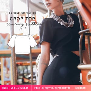 May include: A digital sewing pattern for a black crop top with short sleeves and a wide neckline. The image includes the text GO BOLD, GO FASHION CROP TOP sewing pattern, a line drawing of the top, and size information US 2-14 / EU 34-46.