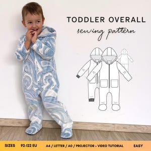 May include: A toddler overall sewing pattern featuring a blue and white marbled print hooded jumpsuit with a front zipper and pockets. The image includes a technical line drawing of the garment and text reading TODDLER OVERALL sewing pattern.